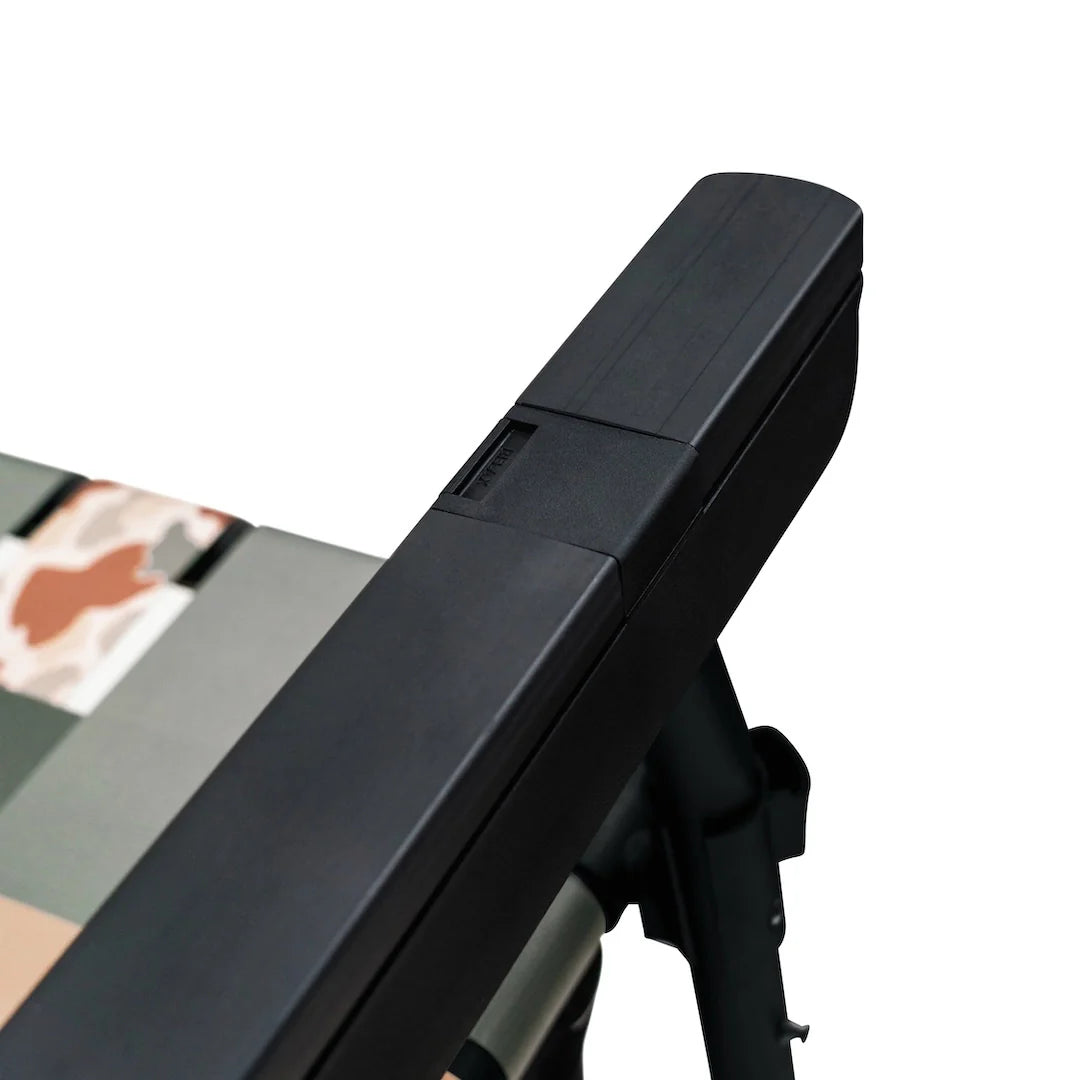 Close-up of the PARKIT Free Fly Eclipse Recliner's armrest featuring the first-class ‚push-to-recline‚ button system, crafted for precision comfort adjustment and ergonomic ease. Made with aircraft-grade aluminum and premium black hardware, this reclining beach and camping chair combines durability, function, and modern design, perfect for outdoor adventures or relaxing at home.