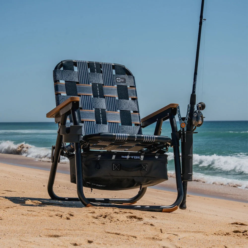 PARKIT x Salty Crew Voyager Chair in limited-edition topo-map pattern, featuring woven webbing, black steel frame, wooden armrests, built-in cooler, cup holder, and backpack straps, rugged 3-in-1 outdoor chair built for surf, fish, and adventure.